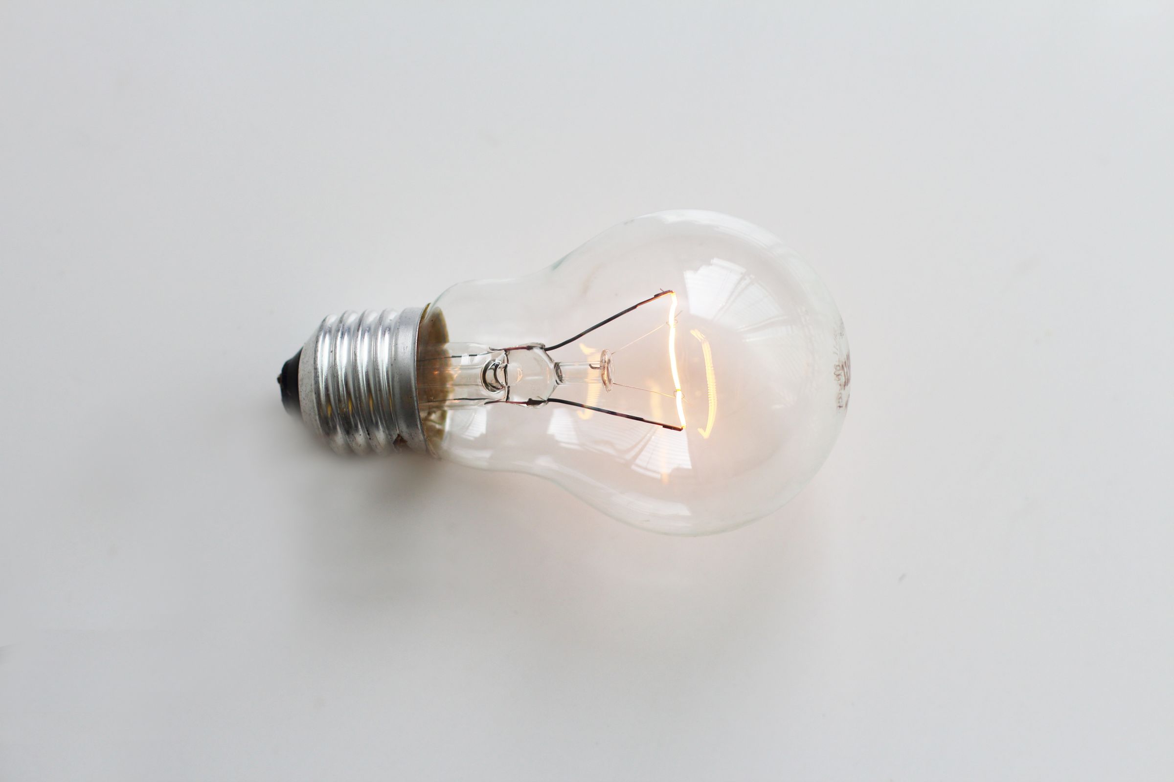 A lit incandescent bulb with a glowing filament