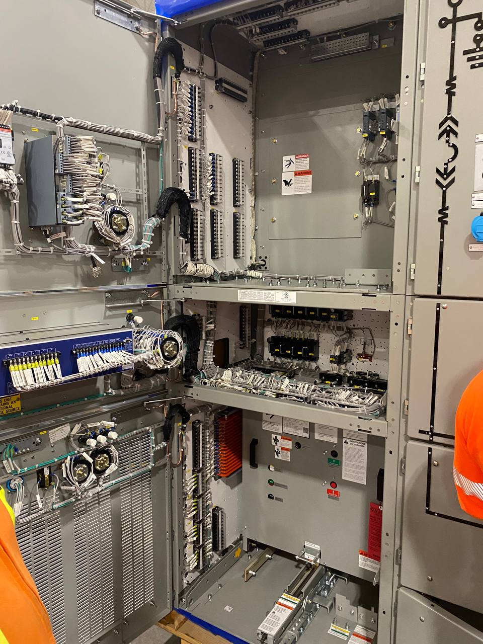Open control cabinet with dense, tidy field wiring