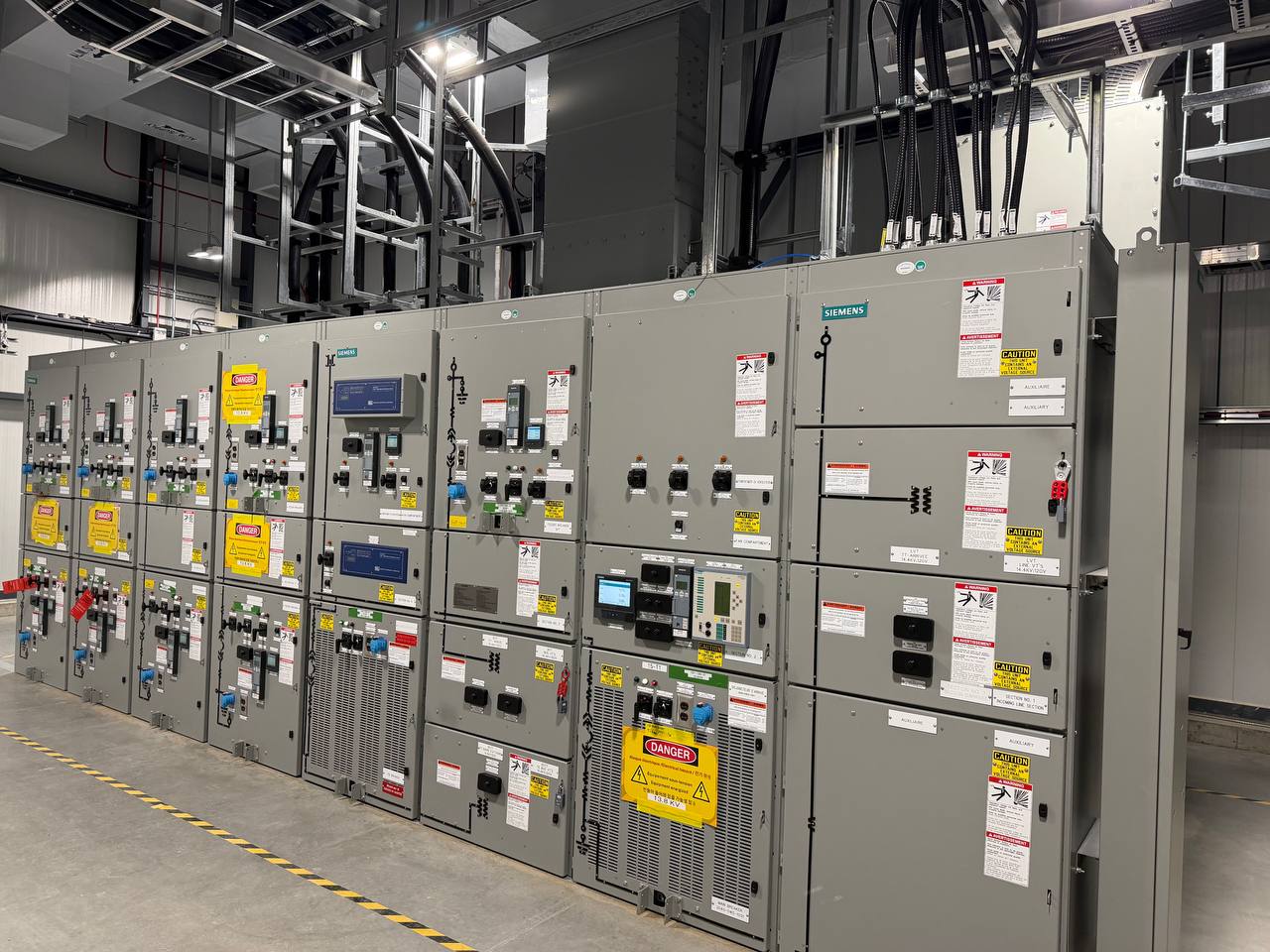Row of medium-voltage switchgear in a commercial electrical room