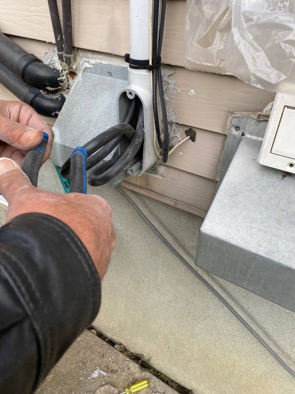 Working on the outdoor service entrance at a Toronto home